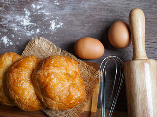 Top View Homemade croissants on wooden background.
