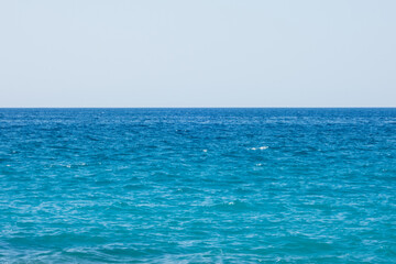 Fototapeta na wymiar Bright blue sea on a windy and sunny day