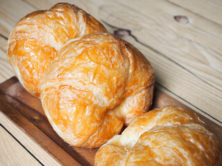 Top View Homemade croissants on wooden background.