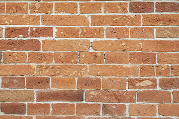 Textured red brick wall from old stones