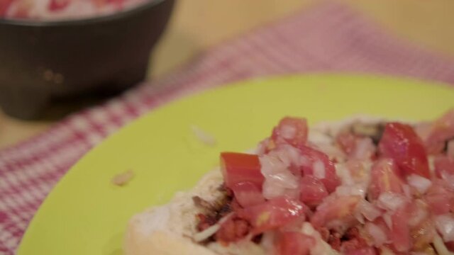 Traditional Mexican molletes on a plate above white and red checkered napkin