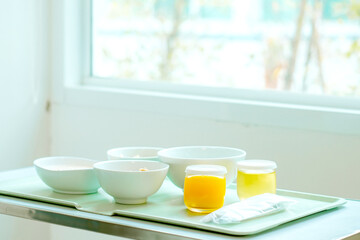 Food tray on the table in a room of a hospital. Patient and hospital concept. Copy space. 