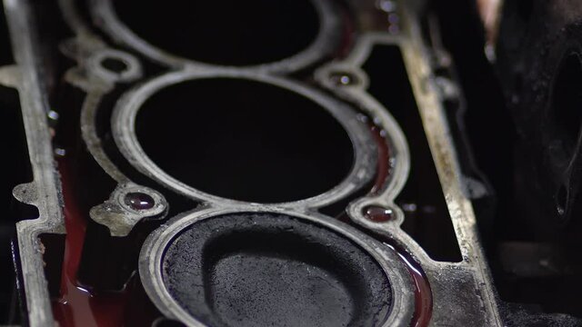 Disassembled motor engine of a car on a repair at the mechanic.The cylinder block of the four-cylinder engine. Closeup