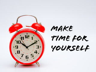 A red clock isolated on a white background with phrase "MAKE TIME FOR YOURSELF".