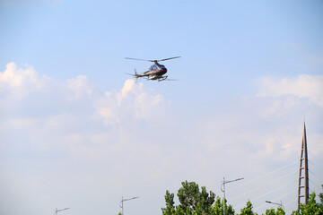 Fototapeta na wymiar Agricultural helicopters for controlling Hyphantria cunea spray pesticides over the city
