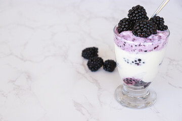 close up of blackberries with yogurt, copy space