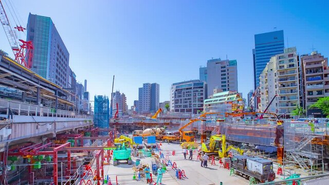 A timelapse of moving cranes at the under construction in Shibuya wide shot zoom