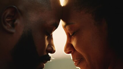Artistic romantic moment between two lovers, African ethnicity with sunlight lens-flare, good for transition