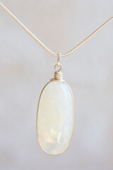 Mineral moon stone sterling silver simple pendant on neutral background
