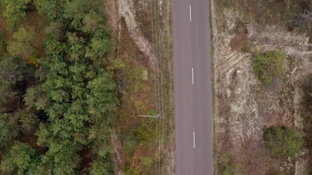 Aerial shooting of car on country road. Aerial view of vintage black bmw on country road