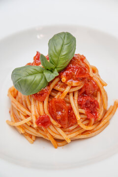 Fine lunch italian restaurant dish, detail is close to a dish with spaghetti al pomodoro.