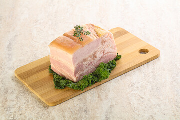 Cut of pork bacon over board