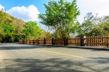 Empty asphalt road and mountain scenery on sunny day.