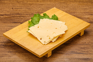 Sliced yellow cheese over board