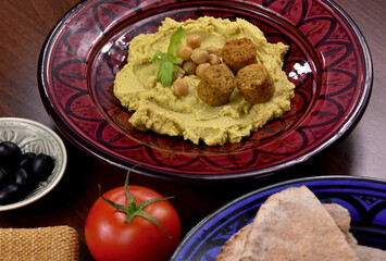 Chickpea hummus with falafel close-up stock images. Traditional homemade hummus served with pita bread still life stock images. Delicious Middle Eastern cuisine photo