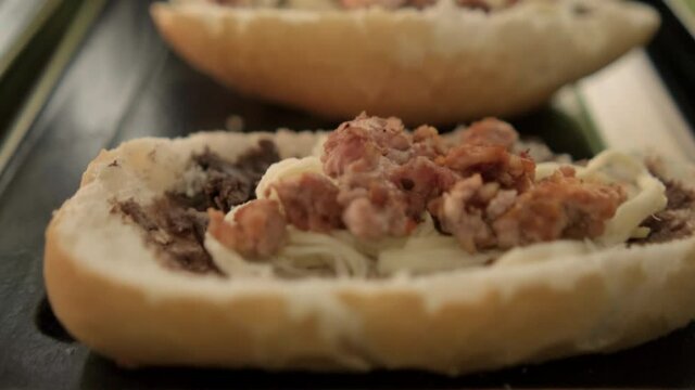 Three traditional Mexican molletes on a black tray