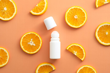Flat lay composition with natural deodorant and orange slices on color background.