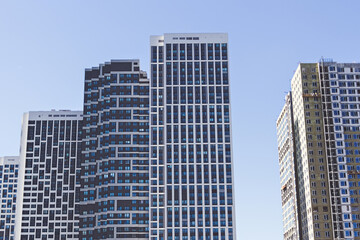 Fototapeta na wymiar Modern high-rise apartment buildings. Housing for urban families in a residential area.