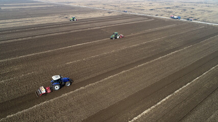 Farmers drive tractors to level up land, North China