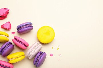 Delicious colorful macarons on beige background, flat lay. Space for text