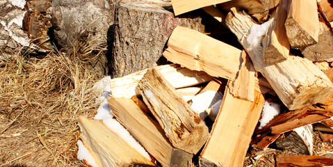 Abstract photograph of piles of natural wooden logs. Background. Harvesting firewood for the winter. Texture. Wood for the fireplace. Birch boards. Macrosymka. Copy space