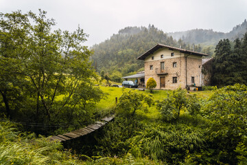 Fototapeta na wymiar A beautiful farmhouse in the rain forest. Spring on the road from Ispaster to Lekeitio, landscapes of Bizkaia. Basque Country