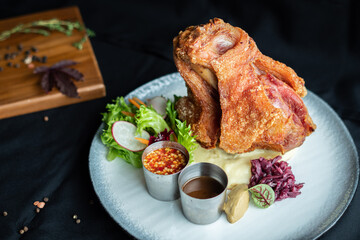 Crispy German Pork Knuckle delicious juicy yummy with in Thai style served with seafood sauce.