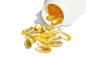 Yellow capsules of vitamin omega-3. Fish oil and omega 3 gel capsules on white background with...