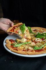 Seafood Pizza ,hand pick pizza, eating pizza and having fun. leisure, food and drinks, people and holidays concept