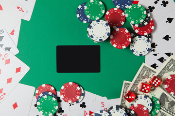 Classic playing cards, chips, red dice and dollars on green background. Gambling and casino concept.