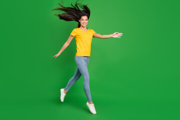 Fototapeta na wymiar Full length body size photo dreamy girl brunette hair jumping up smiling isolated vivid green color background