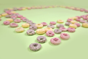 Colorful cereal on a green background