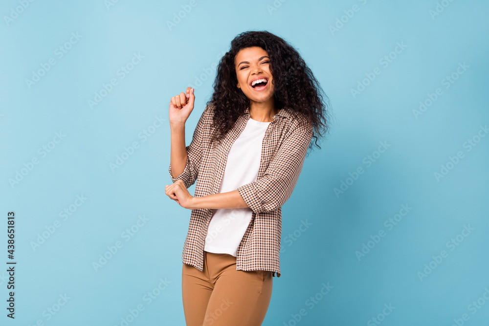 Sticker Photo of funny charming dark skin woman dressed checkered shirt dancing smiling isolated blue color background