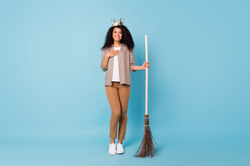 Photo of adorable cute dark skin lady wear plaid shirt smiling arm chest holding broom isolated...