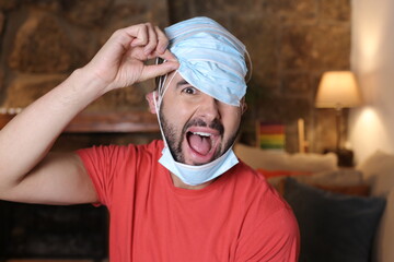 Exaggerated man covering his head with surgical masks