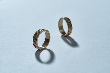 Pair of stylish gilded rings with carvings