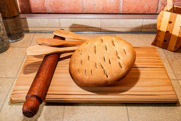 delicious freshly baked artisan bread, nutritious, homemade, fresh and healthy wheat flour, on a wooden board, top view close up.