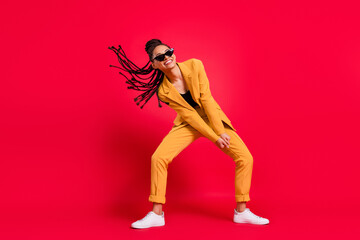 Full size photo of cute lady dance wear eyewear yellow suit isolated on vivid red color background