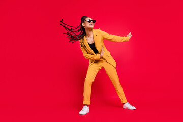 Full size photo of funny lady dance wear eyewear yellow suit isolated on vivid red color background