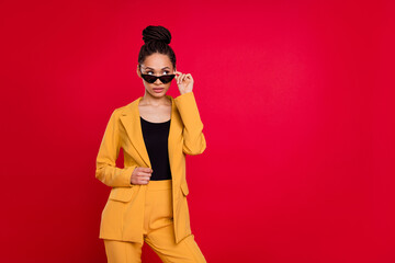 Photo of curious work lady look empty space wear eyewear yellow cardigan isolated on vivid red color background