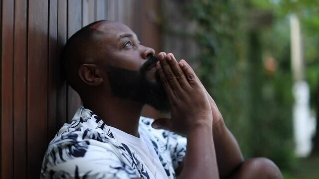 Black African man looking at sky with GRATITUDE and FORGIVENESS