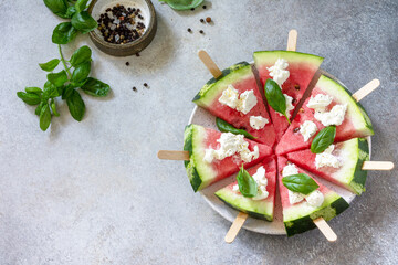 Healthy seasonal dieting and nutrition, summer snack. Watermelon pizza with feta cheese and basil...