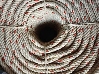 The white and red colored manila rope was neatly wrapped in a circle. Available in stores For those...