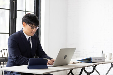 Fototapeta premium young businessman working with laptop computer in office