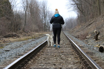 person walking on railroad tracks
