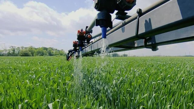 Agricultural Industry.Treatment of Plants in the Fields by Spraying. Spray Nozzle Close-up.The Tractor Moves through the Field working on Pests