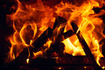 A fire burns in a fireplace, Fire to keep warm. Logs burning in a fireplace