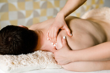 Obraz na płótnie Canvas Back and shoulder massage for men in a beauty salon. Health care concept