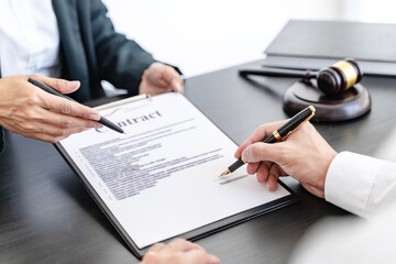 Lawyer preparing to sign a contract reading documents at meeting