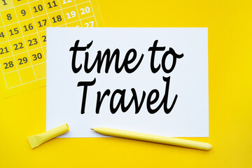 ABSTRACT CALENDAR, paper, pen on yellow background with text TIME TO TRAVEL